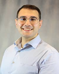 Headshot for Ahmed Ftouni wearing a blue button up shirt.