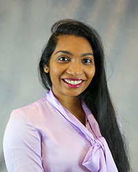 Headshot for Myna Komuravelli wearing a purple top.