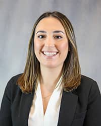 Headshot for Daniela Marcano wearing a black blazer and white top.