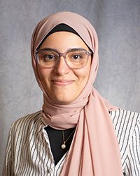 Doaa Aboualla is wearing glasses and a pink headscarf