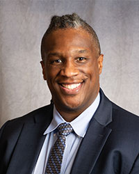 Clifford Davis is in a suit and tie