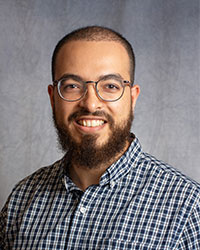 Ellythy, Assem Assem Ellythy has a beard and glasses smiling