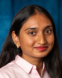 Amaravadhi, Amoolya a woman with long hair wearing a pink shirt