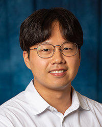 An, Byoungchan a man wearing glasses and a white shirt
