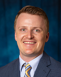 Barrick, Luke a man in a suit smiling