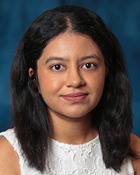 a woman with long black hair and white tank top blouse