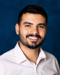 a man with a beard smiling