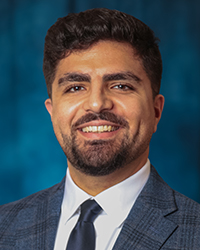 Tanbour, Hesham a man in a suit smiling