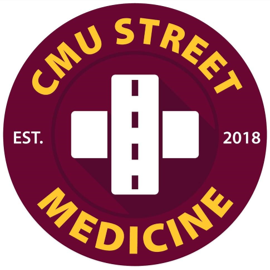 Street Medicine spirit mark A circular maroon logo with the text CMU Street Medicine in yellow around the edge. In the center, there is a white cross with a vertical road icon superimposed. Est. 2018 is also written in white on either side of the cross.