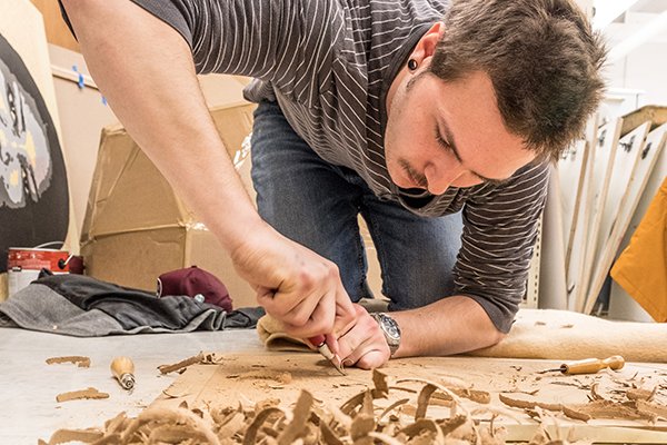 Art student carving a design