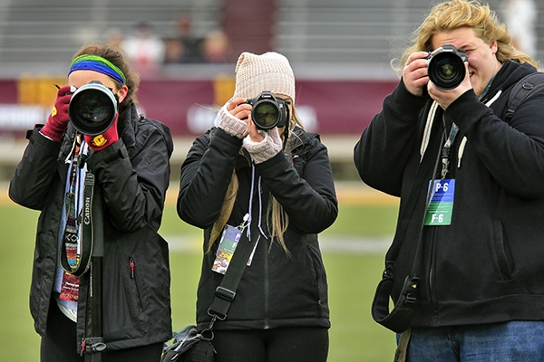 Student photographers at a football game