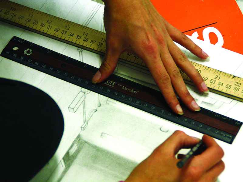 Artist using ruler to draw a straight line