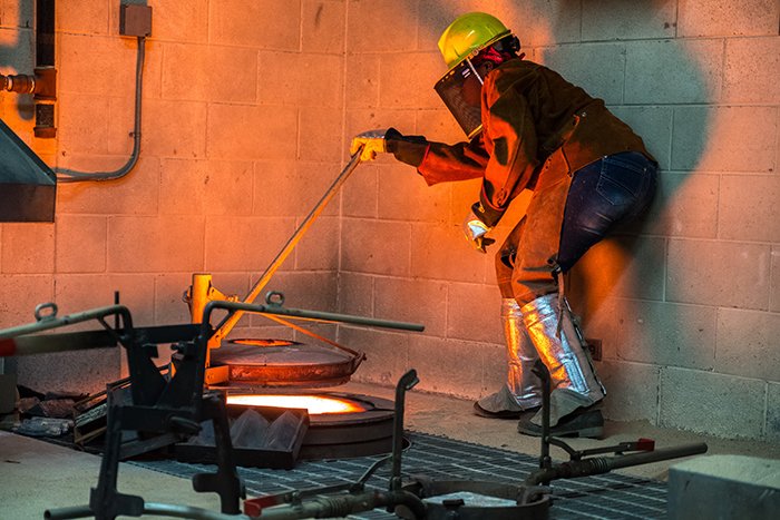 Student heating metal to melted state.
