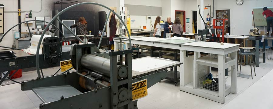 CMU students gathered in a small group working in the art facilities printmaking classroom on the campus of Central Michigan University.