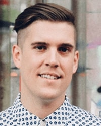 Headshot of Jeremiah Britton in front of a store window.