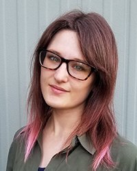 Headshot of Kady Jesko in front of a white paneled backdrop.