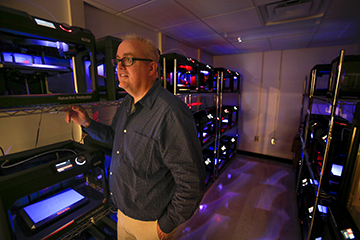 Larry Burditt in the Makerbot lab when it was first opened. You can see the wall of 3D printers behind him.