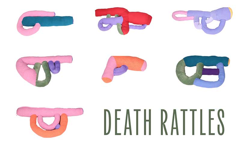 Several soft sculptures of various types of guns in multiple colors. The words "Death Rattles" is printed in the bottom right corner.
