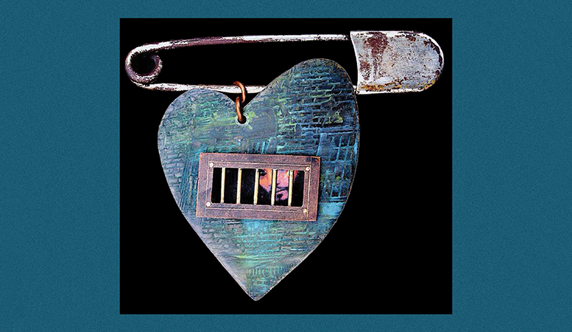 Artwork by James MaloneBeach, a heart locket held by a safety pin. The artist's self portrait is on the heart and behind bars.