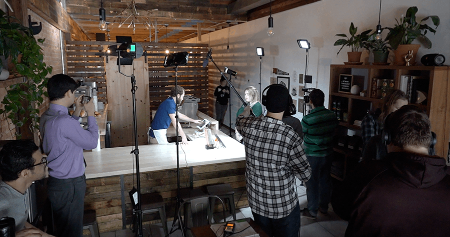 Students working on a film production at a local coffee shop