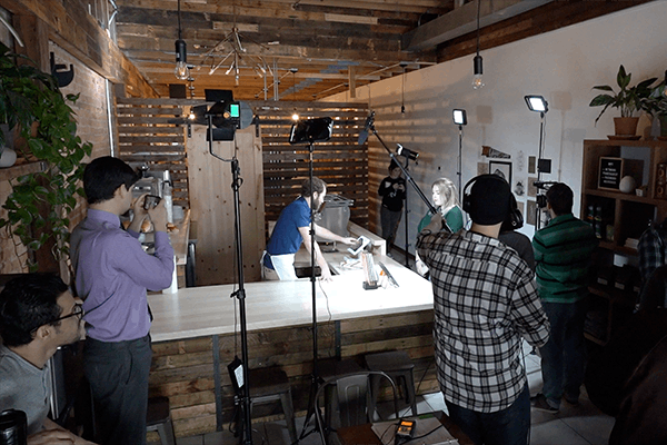 Students working on a film production at a local coffee shop