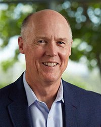 Headshot of Tim Hackbardt with trees in the background.