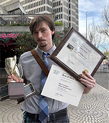 Journalism student Blace Carpenter holding his many awards won through his work with CM Life