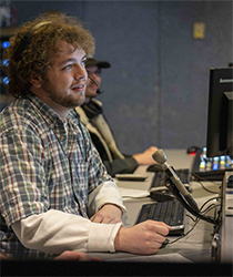 Cinematic Arts student Hugh Service working as a producer in the MHTV studio