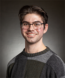 Headshot of Mark Hoover in front of a dark grey backdrop