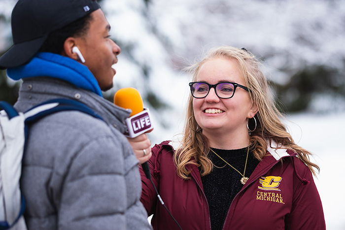 CM Life's Alanna Sparks is interviewing a fellow CMU student for CM Life, the student run newspaper on the campus of Central Michigan University.