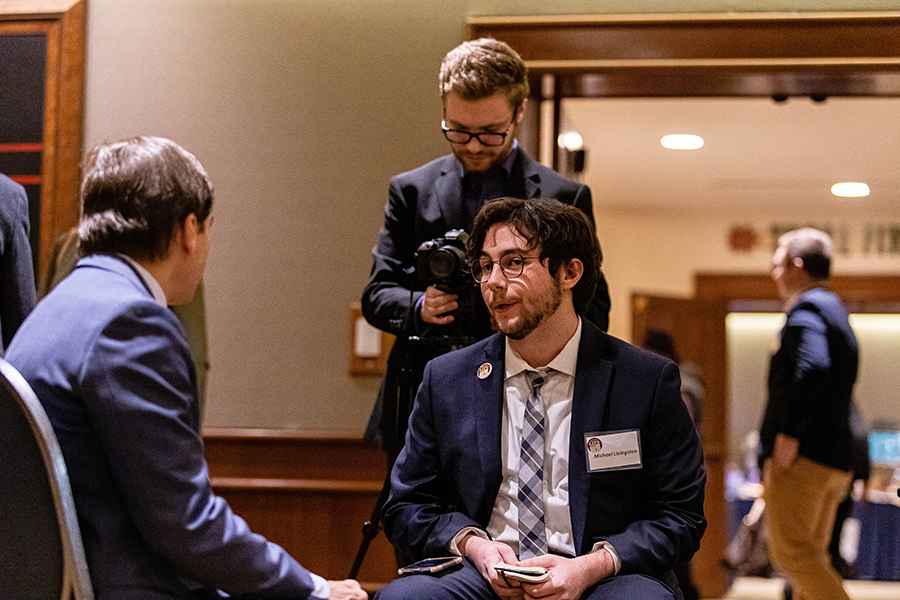 Students in suits conducting an interview