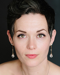 Headshot of Emily Marvosh on a dark grey backdrop.