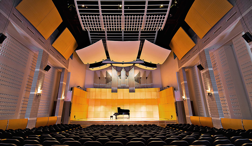 Staples Family Concert Hall with a backlit piano on stage.