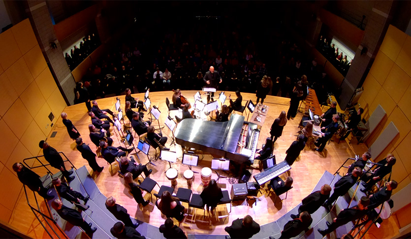 Arial Shot of Staples Family Concert Hall Featuring Members from the CMU Choirs and Symphony Orchestra.