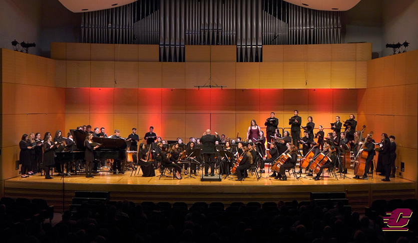 CMU students, a part of both the orchestra and choir, perform opera on stage at Staples Family Concert Hall.