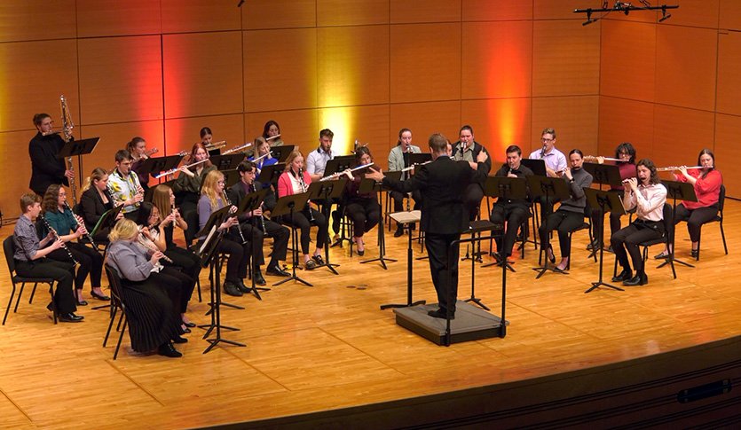 Combined flute and clarinet choirs performing in Staples Family Concert Hall.