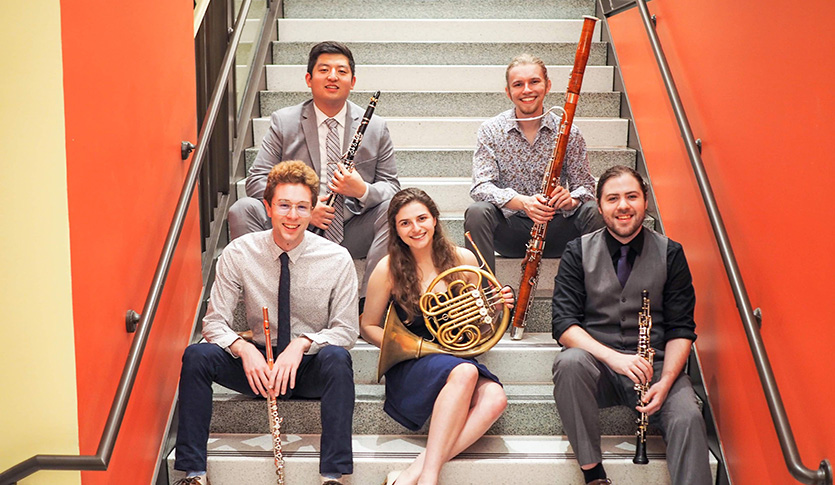 CMU guest artists Kodan Quintet sitting on a staircase, each holding their instrument.