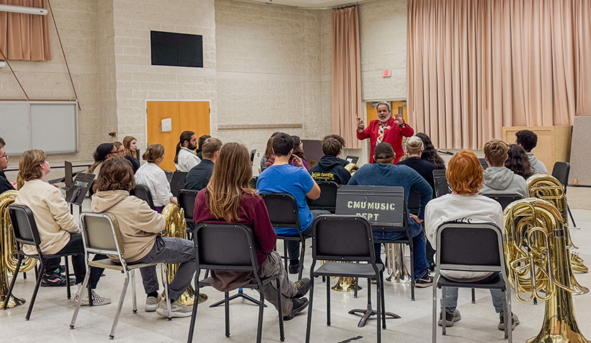 Dr. Mark Cox teaches a classroom full of brass players in the Band room of the CMU School of Music.