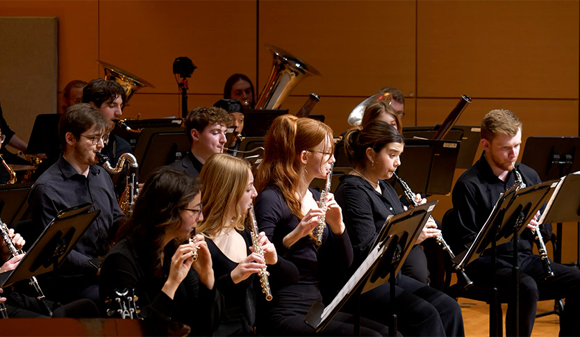 The CMU Symphonic Wind Ensemble performing a concert in Staples Family Concert Hall.