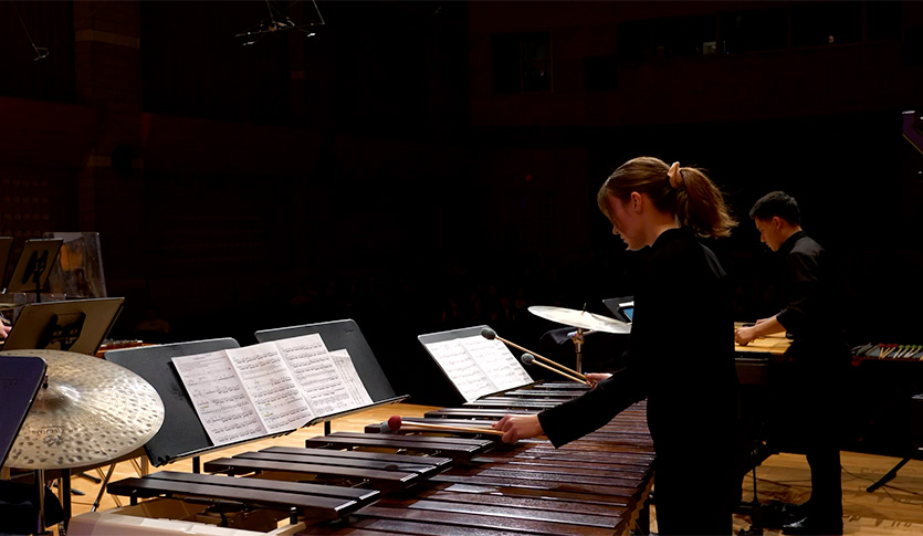 Members of the CMU Percussion Ensemble performing on marimba in Staples Family Concert Hall.