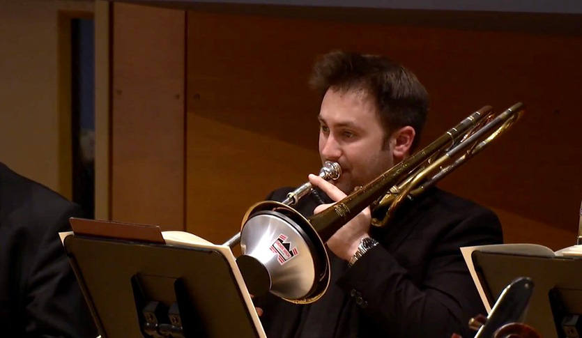 Trombonist Carson King-Fournier performing in an ensemble.