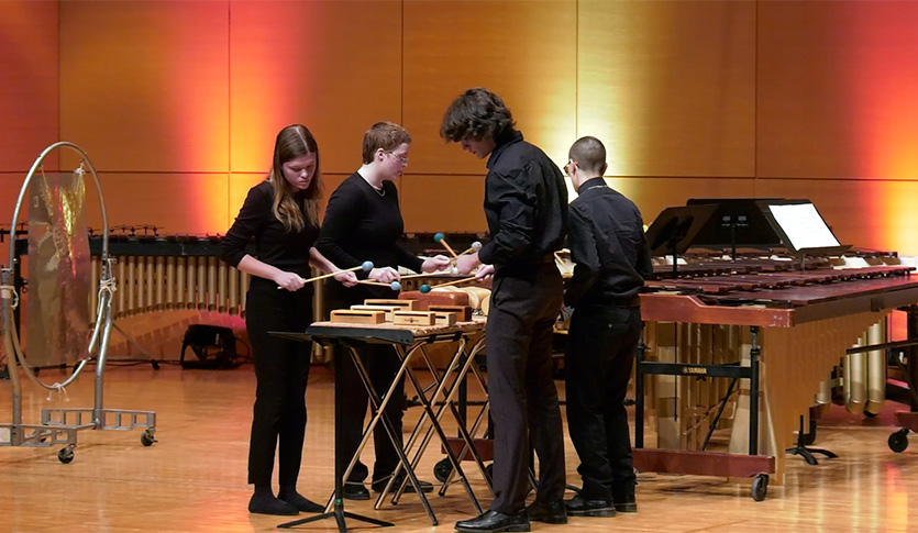 CMU Percussionists performing on wood blocks in Staples Family Concert Hall.