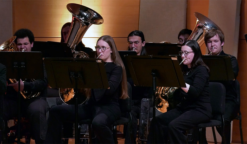 Brass players from the CMU Symphonic Wind Ensemble performing in Staples Family Concert Hall.