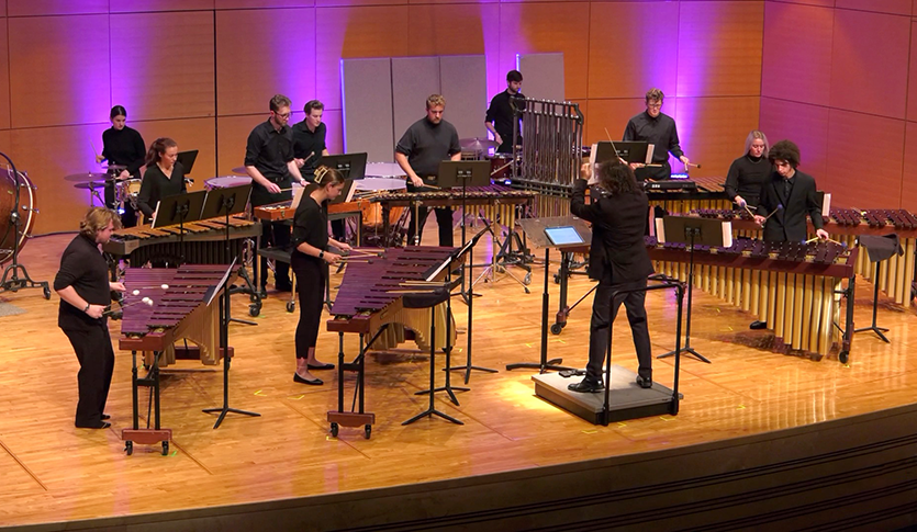 The CMU Percussion Ensemble performing on stage at Staples Family Concert Hall under the direction of Dr. Marco Schirripa.