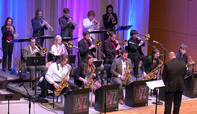 A picture of CMU Jazz Lab 1 performing on stage in Staples Family Concert Hall under the direction of Professor Robbie Smith.