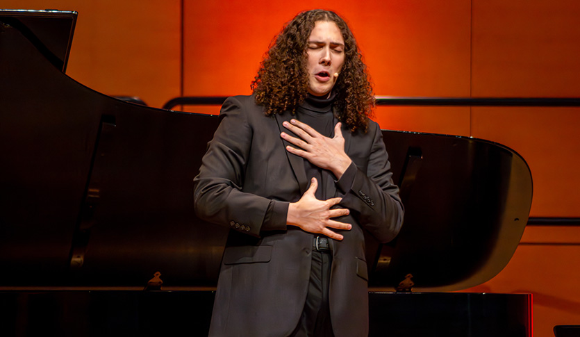 A CMU vocalist expressively performing in Staples Family Concert Hall.