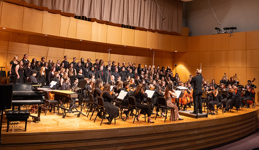 The CMU Choirs and CMU Symphony Orchestra performing together in Staples Family Concert Hall under the direction of Dr. Keith Dodson.