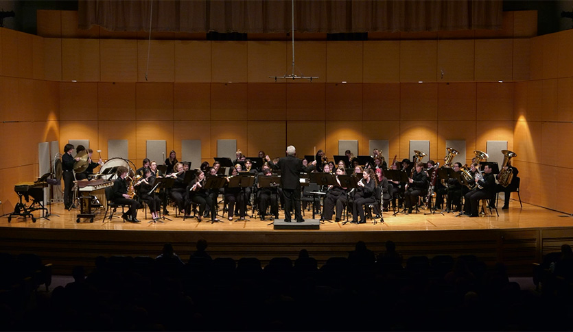 The CMU Wind Symphony under the direction of Dr. James Batcheller, performing in Staples Family Concert Hall.