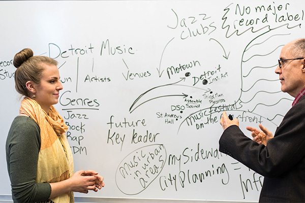 A picture of a CMU music student working with a faculty member
