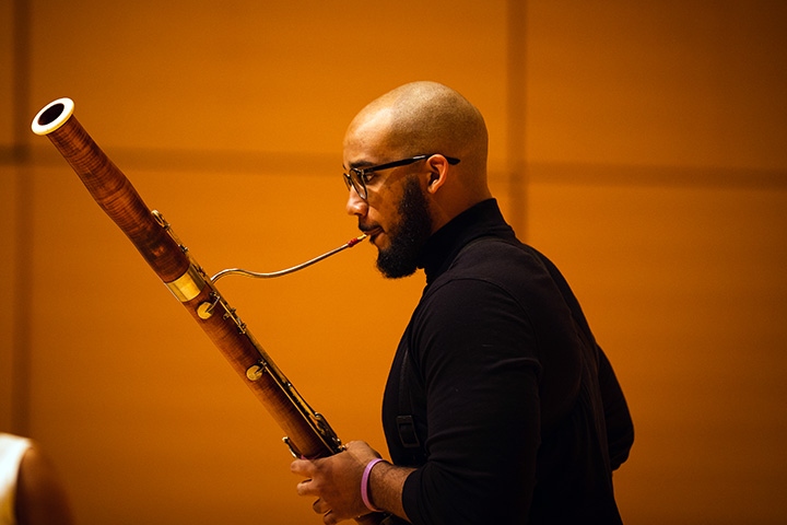 A picture of Carlos Clark playing the bassoon